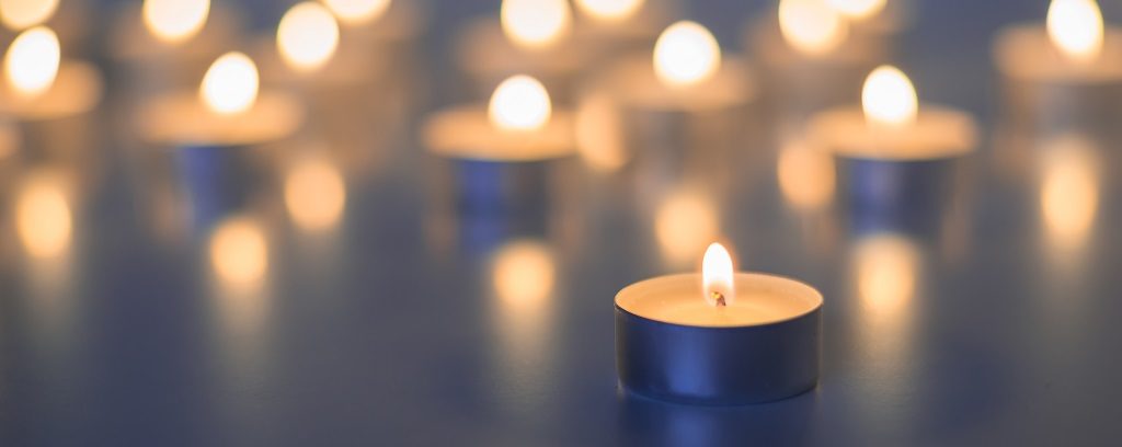 Photo of many tea light candles burning