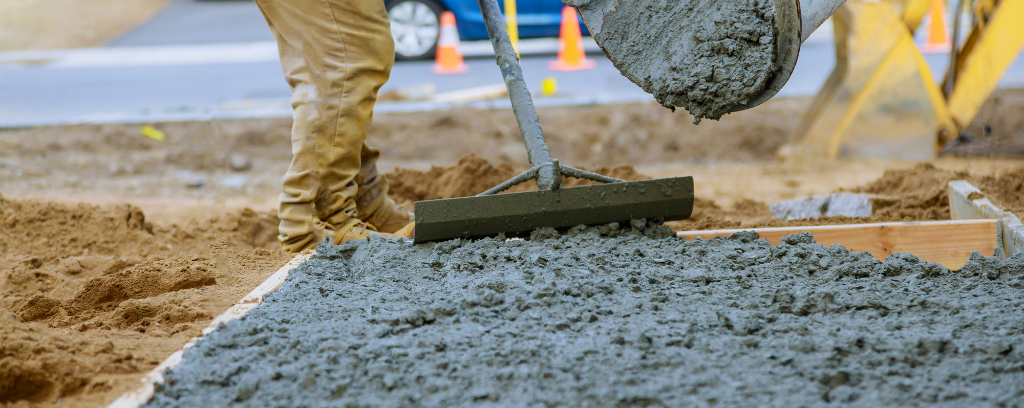 Photo of worker spreading concrete