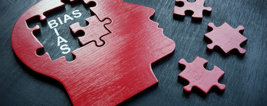 Photo of puzzle in the shape of human head with pieces removed to reveal the word bias