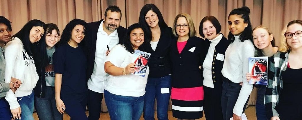 Photo of students, speakers, and administrators at East Side Community High School talk.