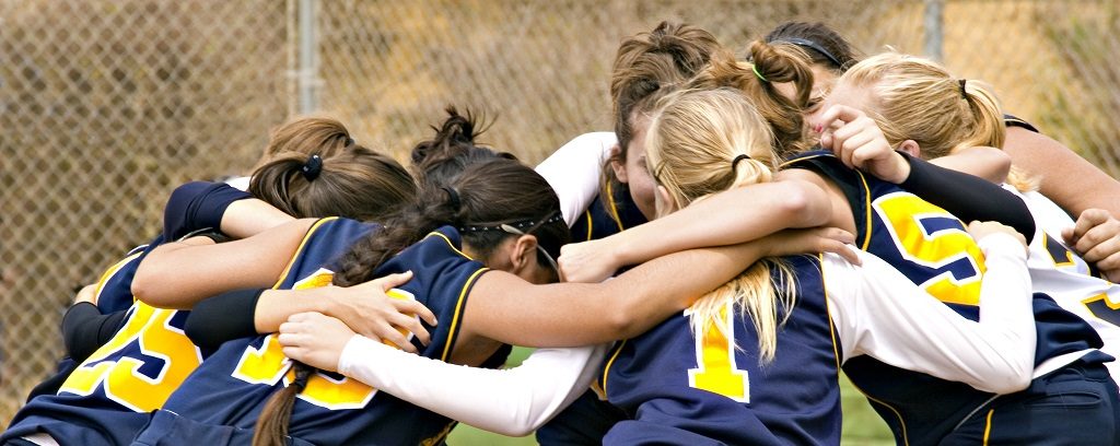 Photo of sports team in a huddle