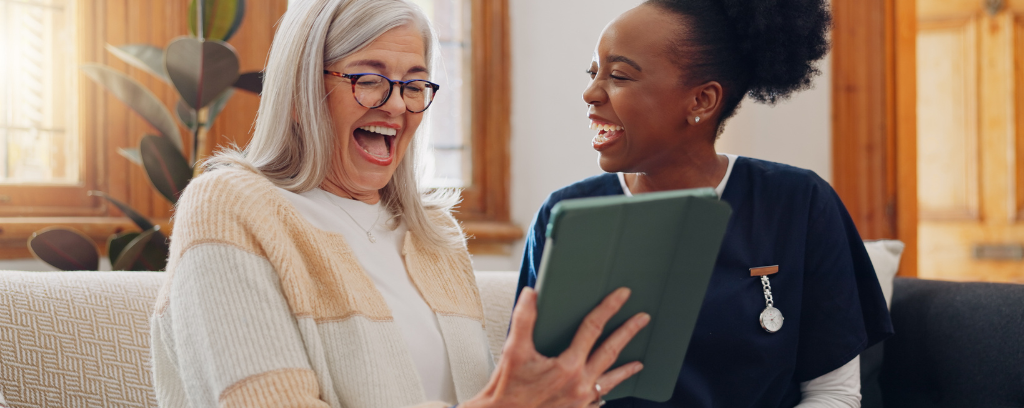 Photo of person with gray hair working effectively with another person without gray hair.