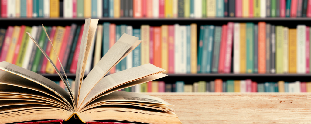 Photo of book open on a table in a library or bookstore.