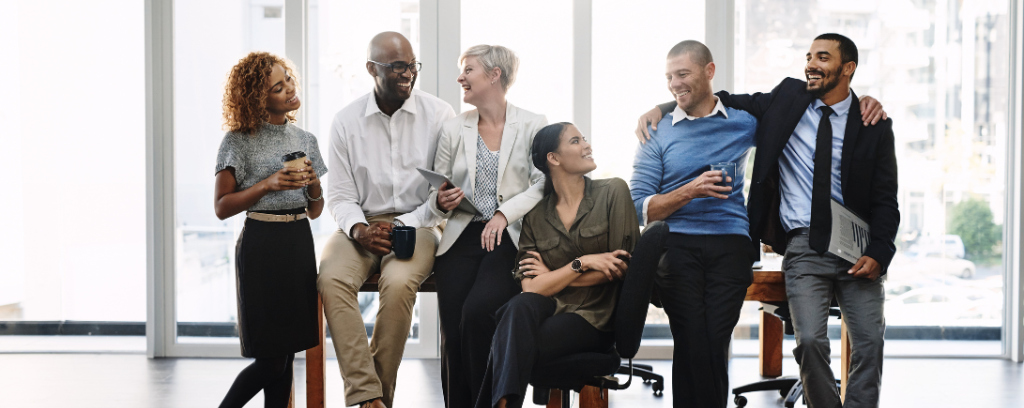Photo of co-workers smiling, talking, and laughing.