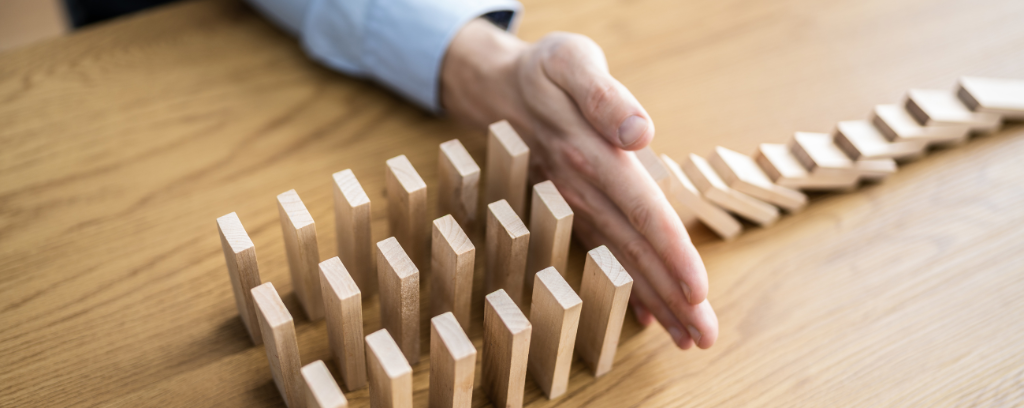 Photo of hand blocking tumbling tiles from other tiles that could also tumble