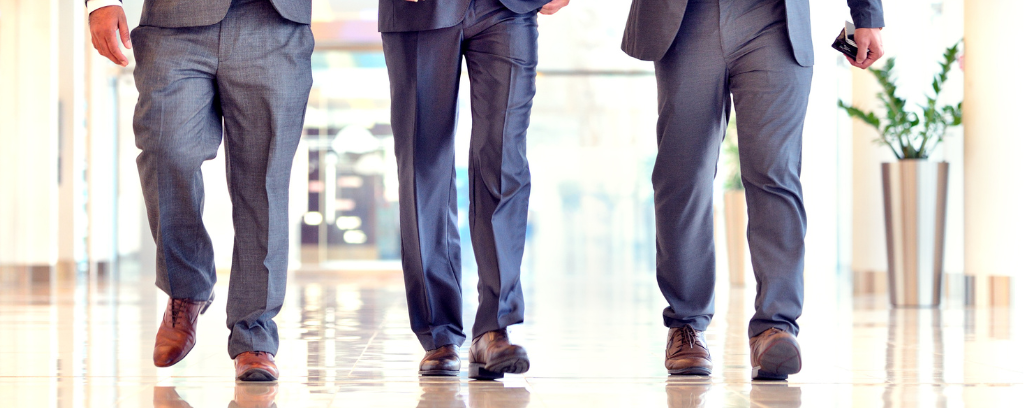 Photo of three men in gray business suits