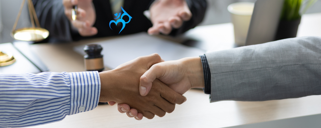 Photo of parties shaking hands after mediation
