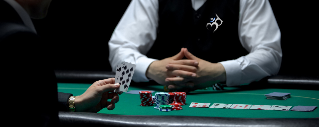 Photo of gambler at table with many chips in front of the dealer