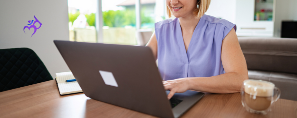 Photo of attorney working remotely on laptop in sunny room with coffee nearby