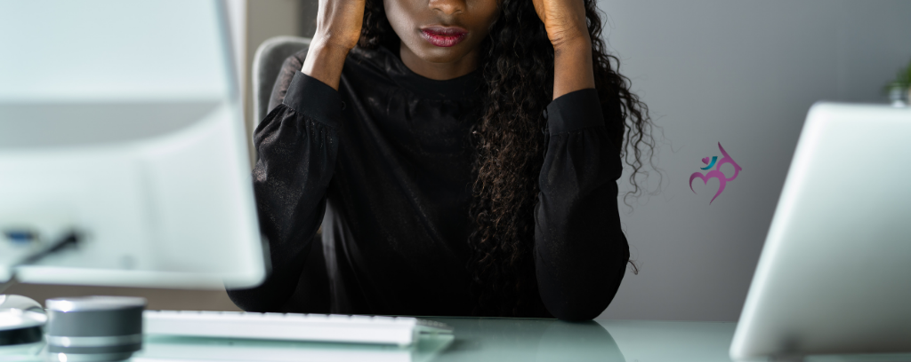 Photo of stressed worker at desk