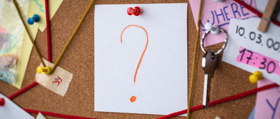 Photo of cork board with evidence and a piece of paper with a question mark
